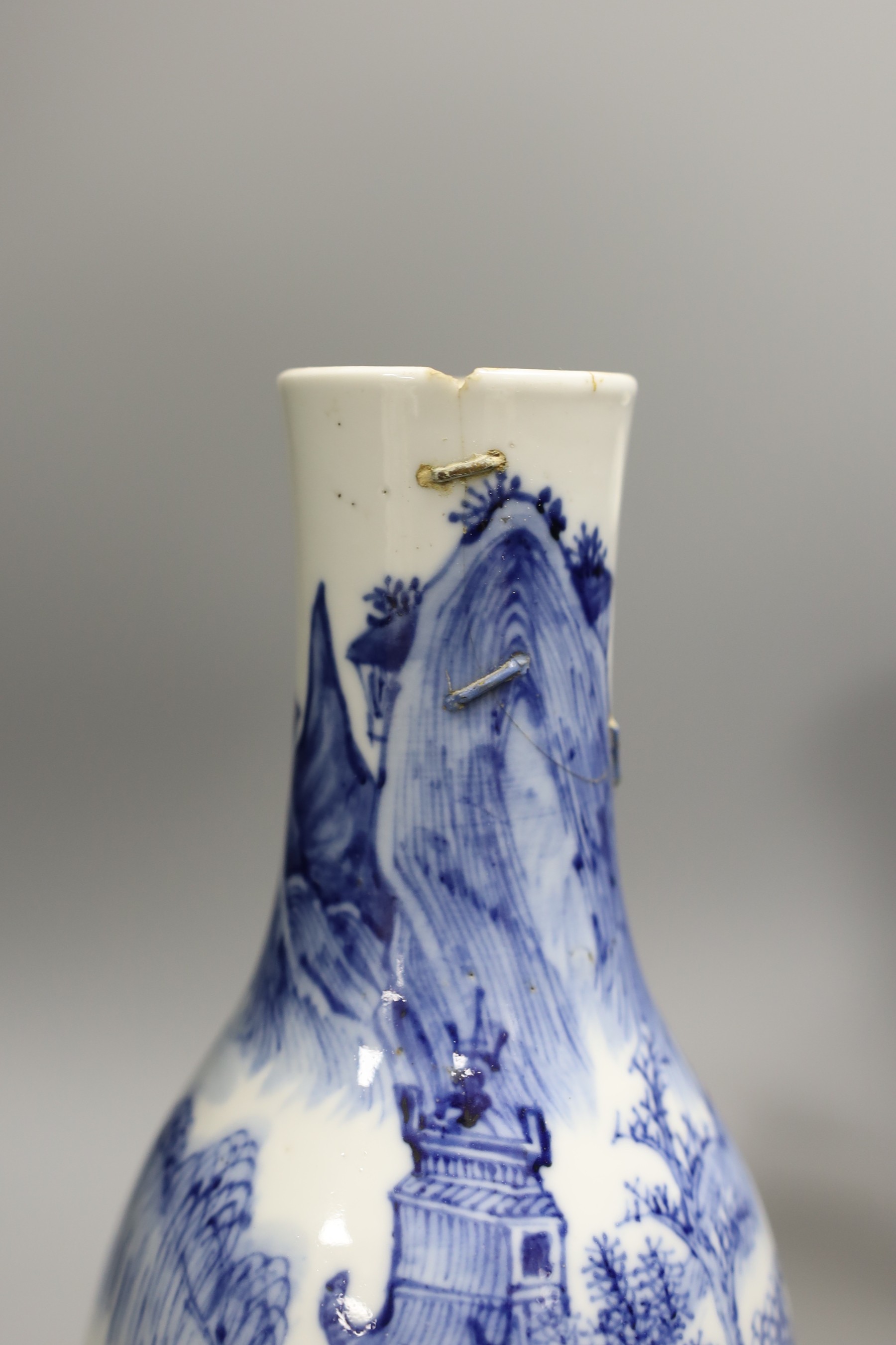 A 19th century Chinese blue and white ‘landscape’ vase, an early 20th century blue and white sleeve vase and three blue and white jars and covers. Tallest 25.5cm